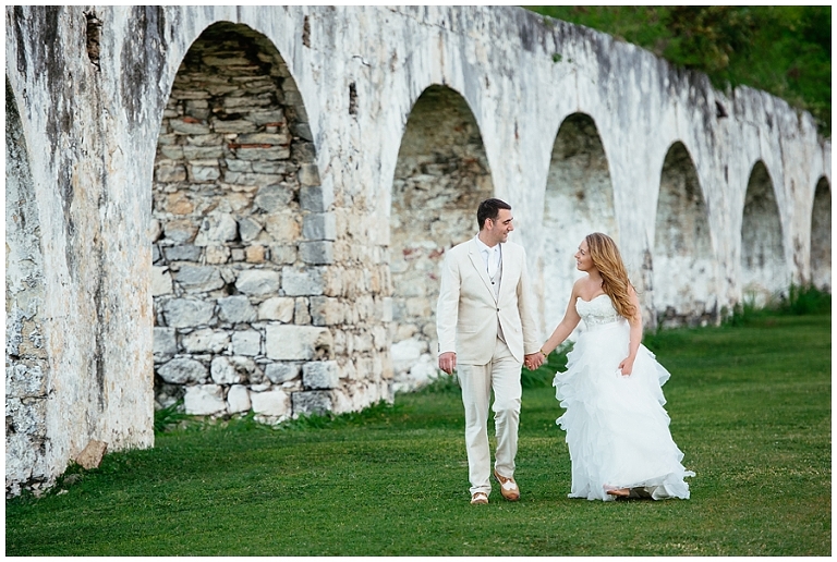 Bride and Groom walking along ruins at Rose Hall Suites for their wedding photos