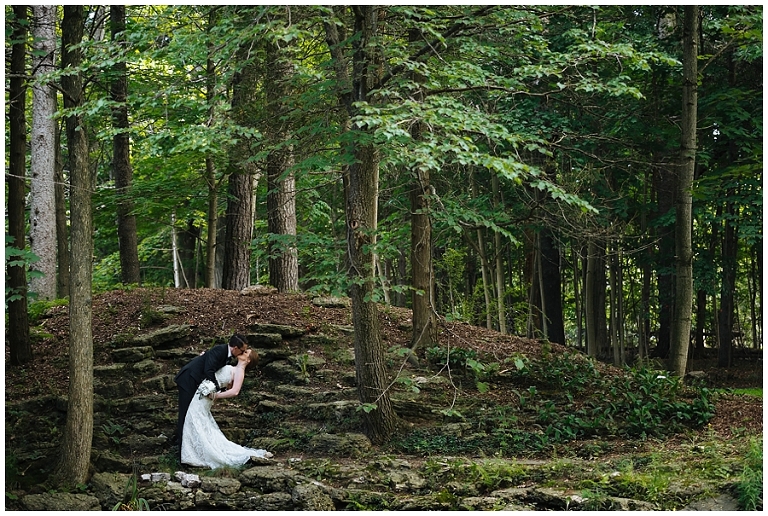 Bride and groom kissing in a forest