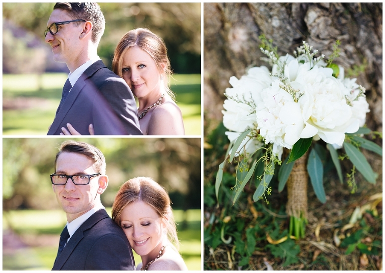 Bride embraces groom from behind and looks at camera