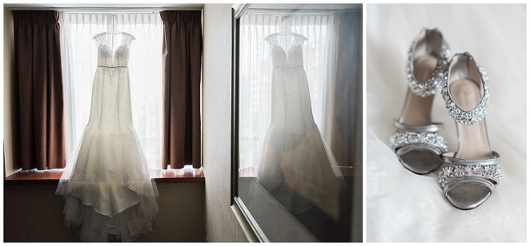Bride's wedding dress hanging in window on her wedding day