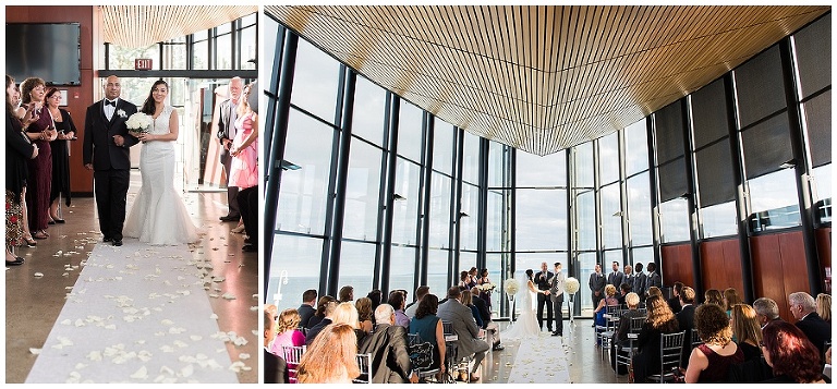 Wide photo of wedding ceremony inside atrium at wedding. Floor to ceiling windows for the bright and airy ceremony