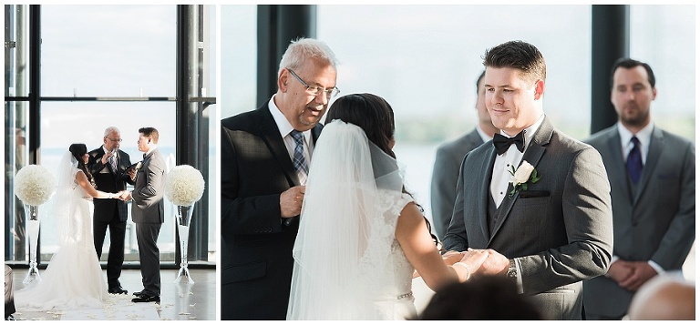 Bride and groom standing at alter in atrium of Spencer's at the Waterfront wedding venue about to say I do