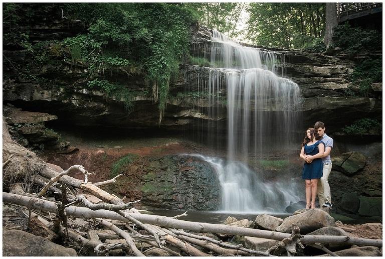Romantic couple engagement photos in front of waterfall in Hamilton