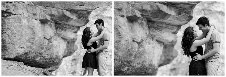 Engaged couple poses underneath cliffs romantically