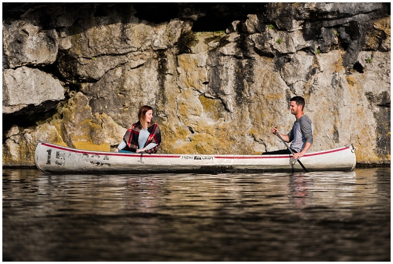 Couples paddles in canoe during Rockwood engagement session