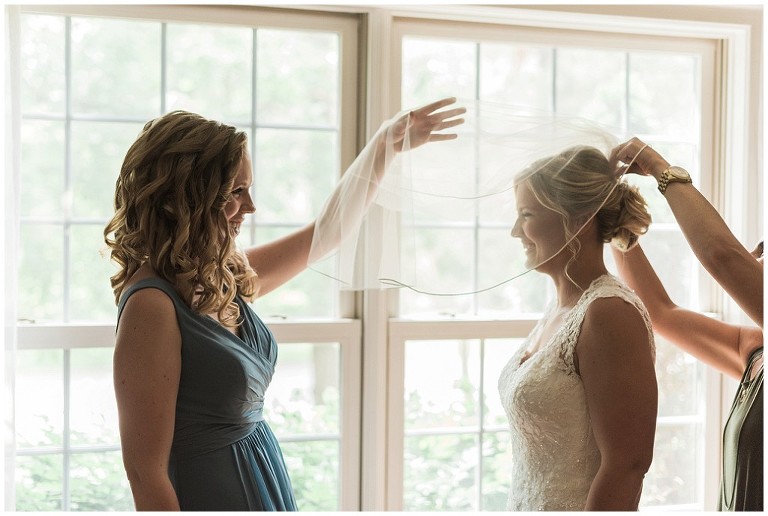 Bride getting ready with bridesmaid