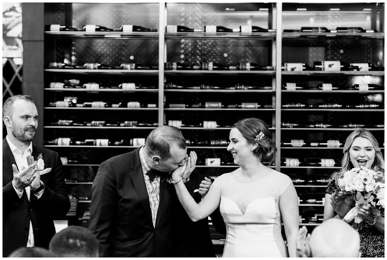 Groom kissing brides hand at jump restaurant wedding