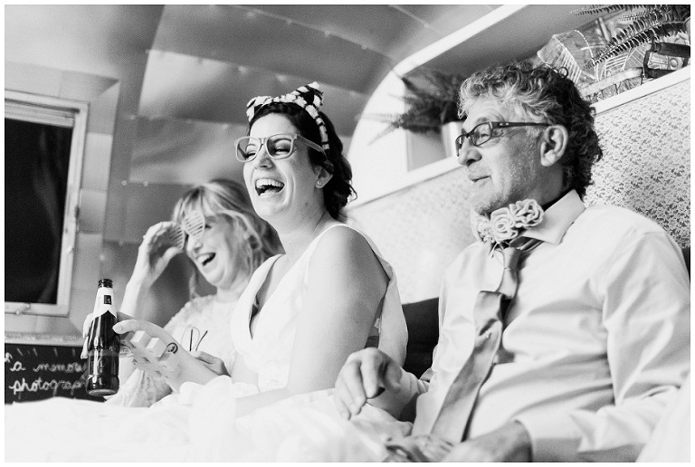 Bride inside airstream photobooth laughing with parents at Kurtz Orchard wedding