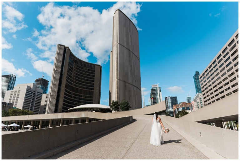 Bride walking up the ramp at Toronto City Hall on her way to the ceremony