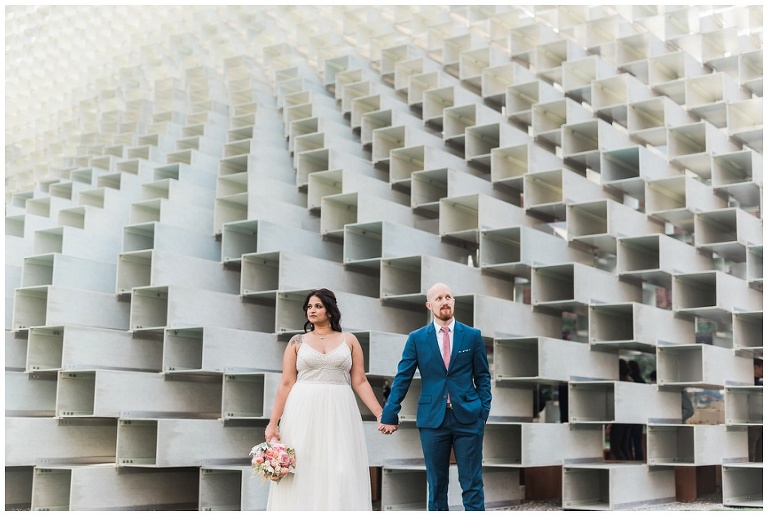 Bride and groom standing in front of architectural wonder Unzipped in Toronto 