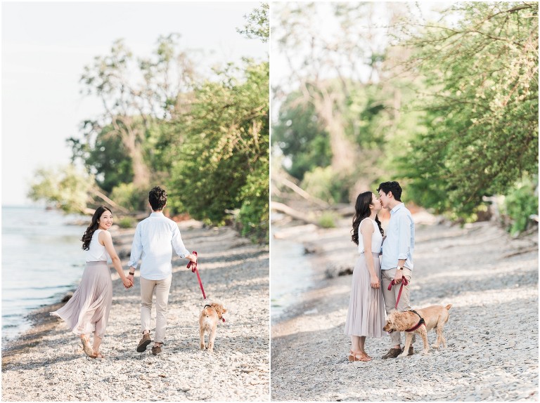 An asian couple walking on a pebble beach with their dog during their engagement session at Jack Darling Park