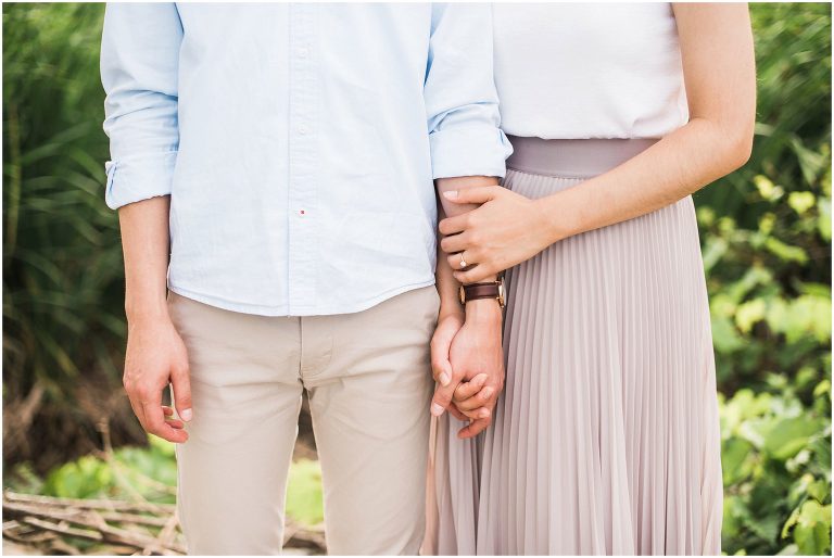 Close up of couple holding hands during their engagement session at Jack Darling Park