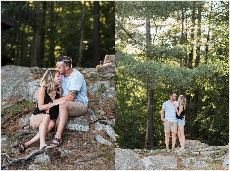 Man and woman sitting on rocks and moss outside of their cottage
