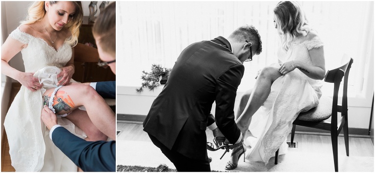 Groom helps tattooed bride put on her shoes on the day of their elopement