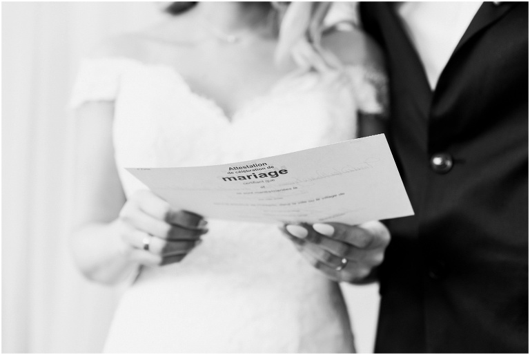 Bride and groom hold marriage license after eloping inside Toronto Wedding Chapel