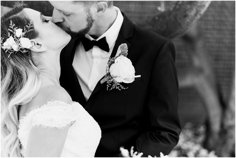 black and white photo of bride and groom kissing after their elopement