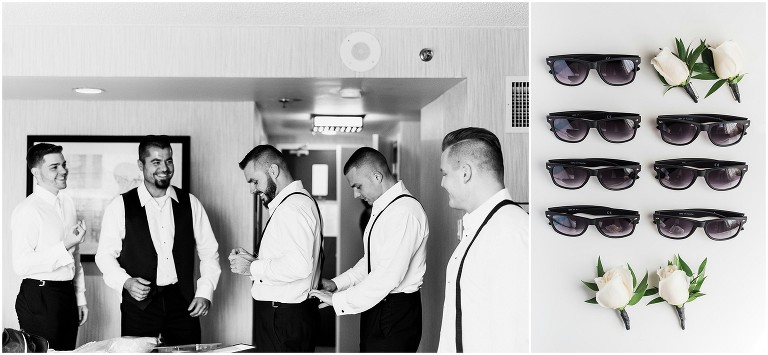 Groom and his groomsmen helping each other getting ready in hotel room while laughing on wedding day at Ancaster Mill