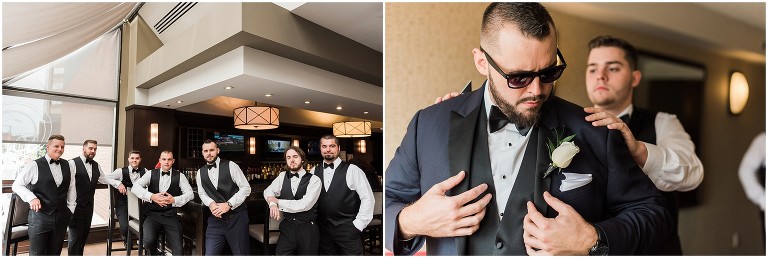 Groom and groomsmen posing for photos in their suits in Sheraton Hotel Hamilton before leaving to go to Ancaster Mill wedding