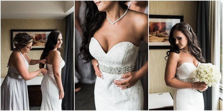 Bridesmaid helping bride zip up her dress on her Ancaster Mill Wedding day