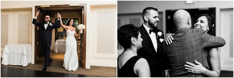 Bride and groom entering into their wedding reception with hands raised and big smiles on their faces