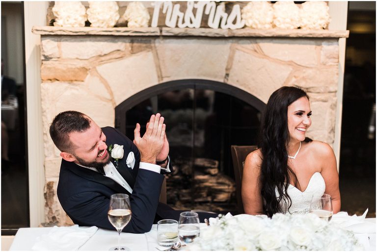 Bride and Groom laughing after speeches at their wedding reception