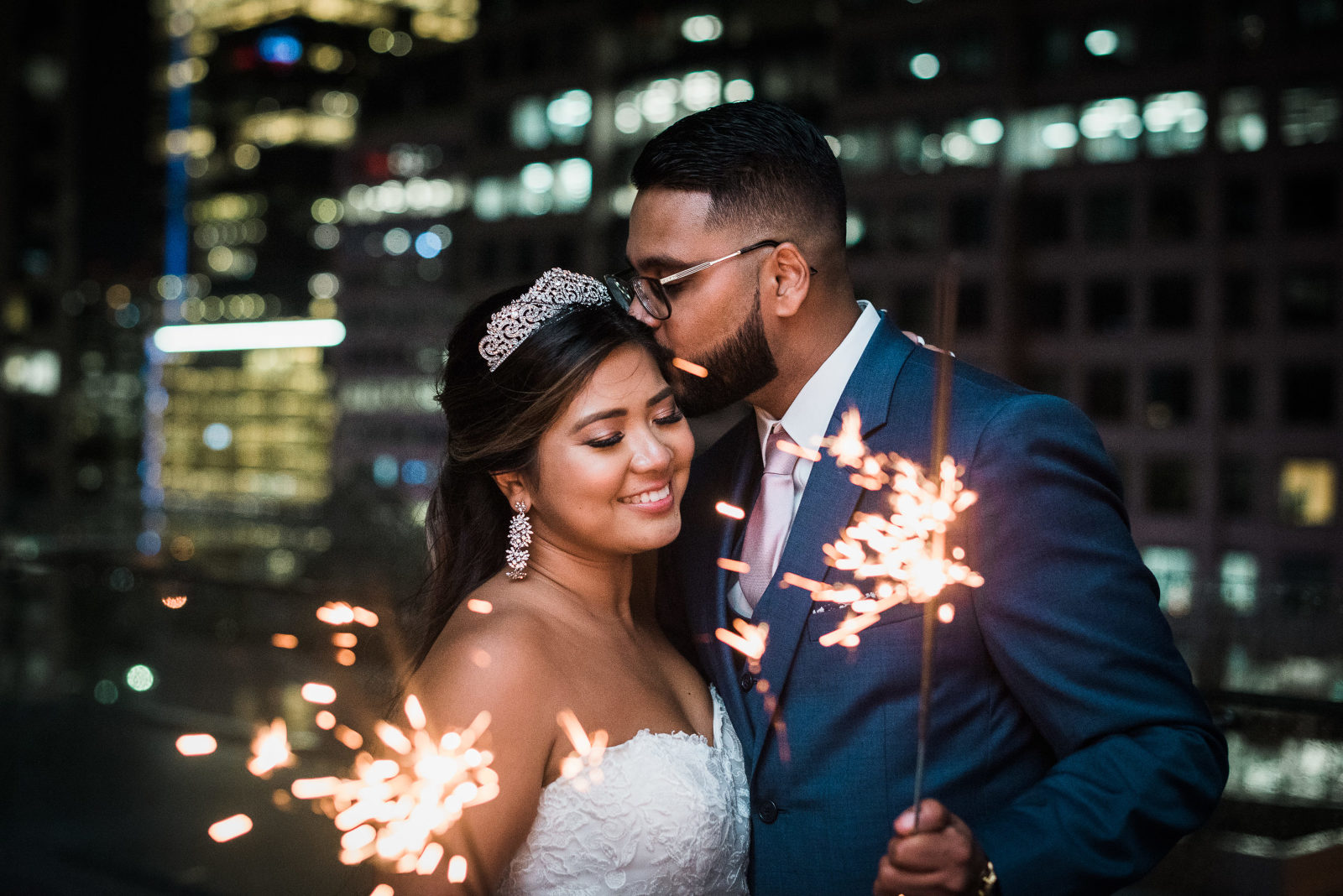 Bride and Groom holding sparklers at night time during their Malaparte Wedding