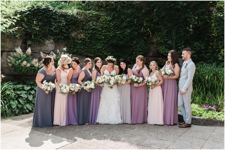 Purple and pink wedding party holding flowers by Forever Wildfield on wedding day at The Manor by Peter and Pauls