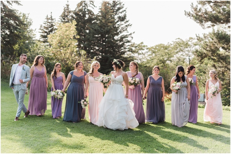 Bridesmaids walking outside together at outdoor summer wedding at The Manor by Peter and Pauls