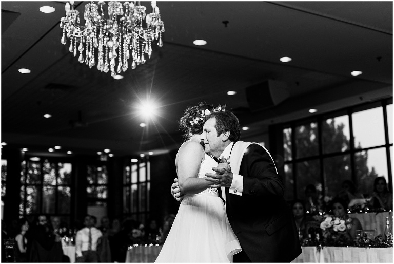Black and white photo of bride dancing with her father at The Manor by Peter and Pauls wedding