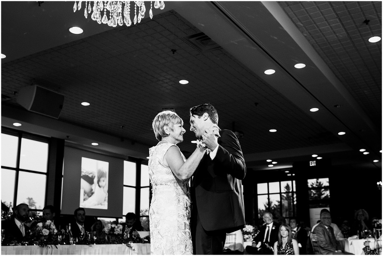 Black and white photo of groom dancing with his mother at The Manor by Peter and Pauls wedding
