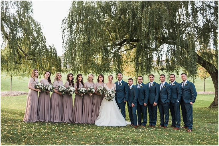 15 person wedding party standing together in front of a willow tree at an elegant Credit Valley Golf and Country Club wedding