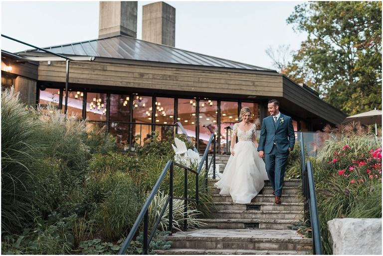 Bride and Groom walking down the stairs at Credit Valley Golf and Country Club during sunset