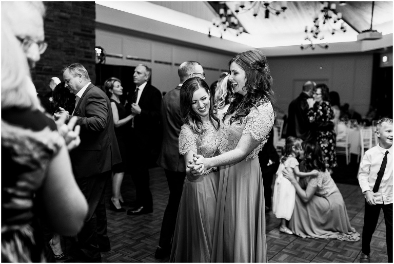 Black and white photo of guests dancing at Black and white photo of bride and groom having fun on the dance floor at their elegant Credit Valley Golf and Country Club wedding
