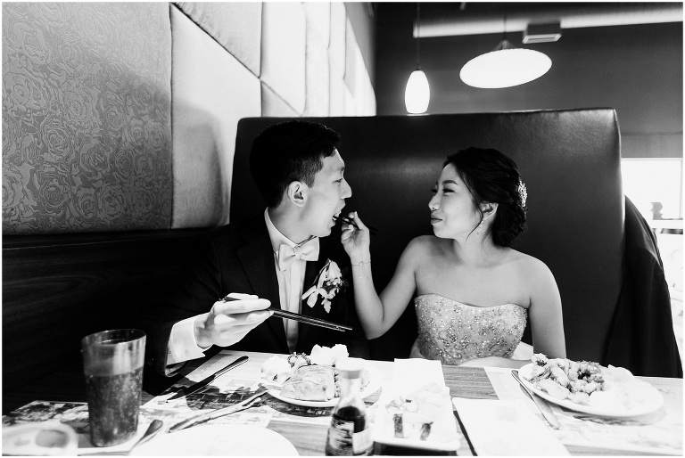 Down-to-earth couple feeding each other sushi on their wedding day