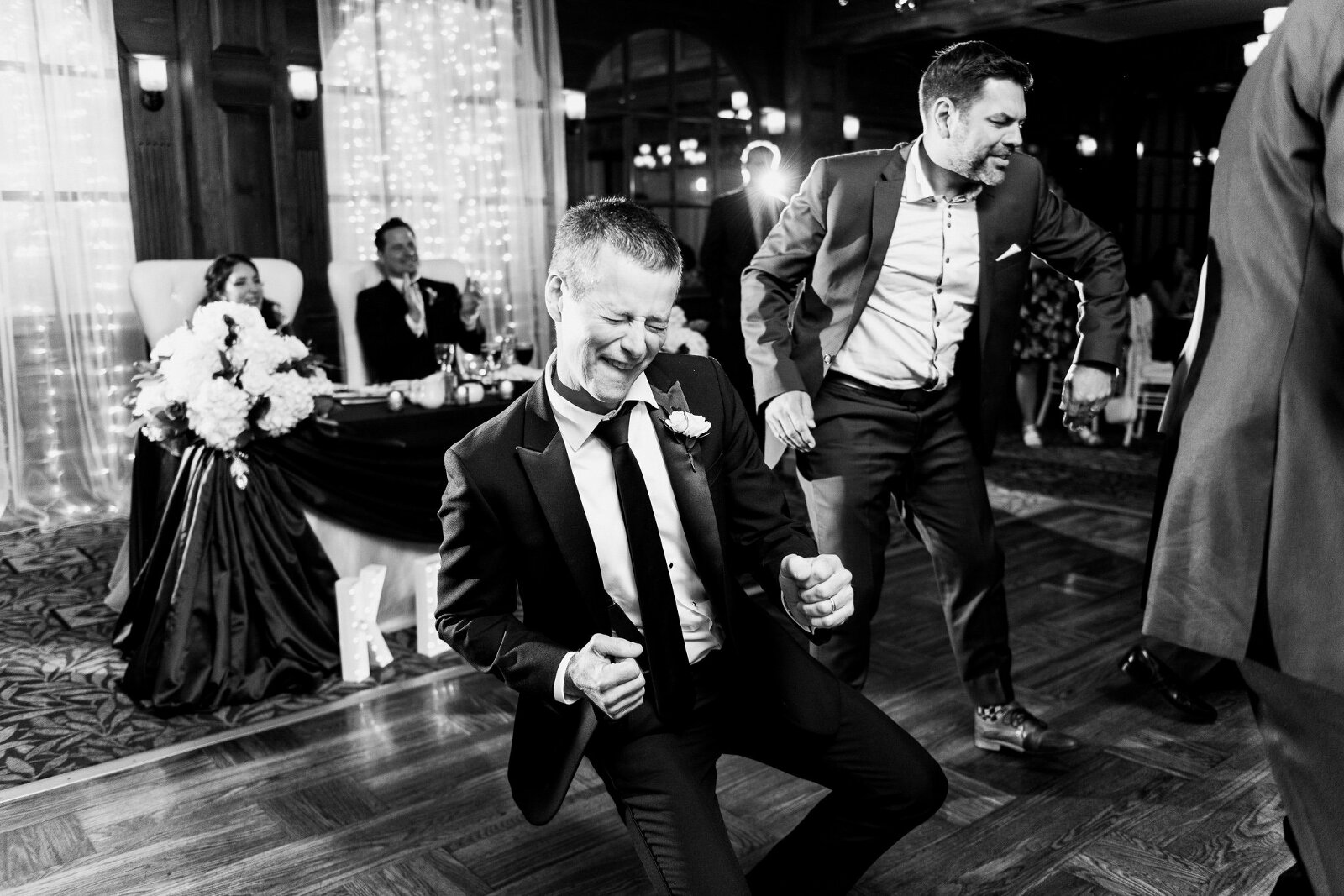 Groomsman gets down on the dance floor at friend's wedding
