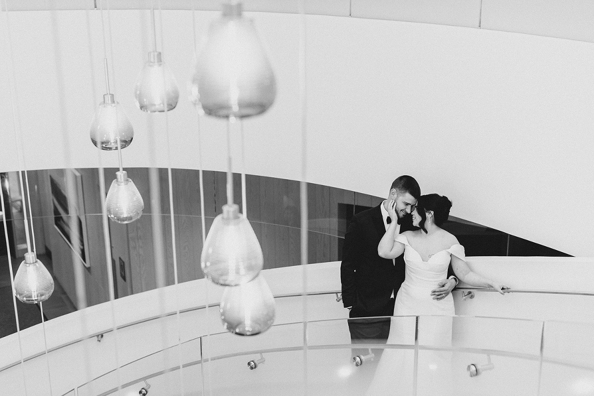 Bride and Groom embracing on the stairway at The Pearle Hotel for their wedding day