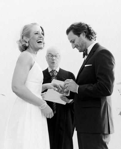 Groom puts ring on bride's finger at Toronto City Hall