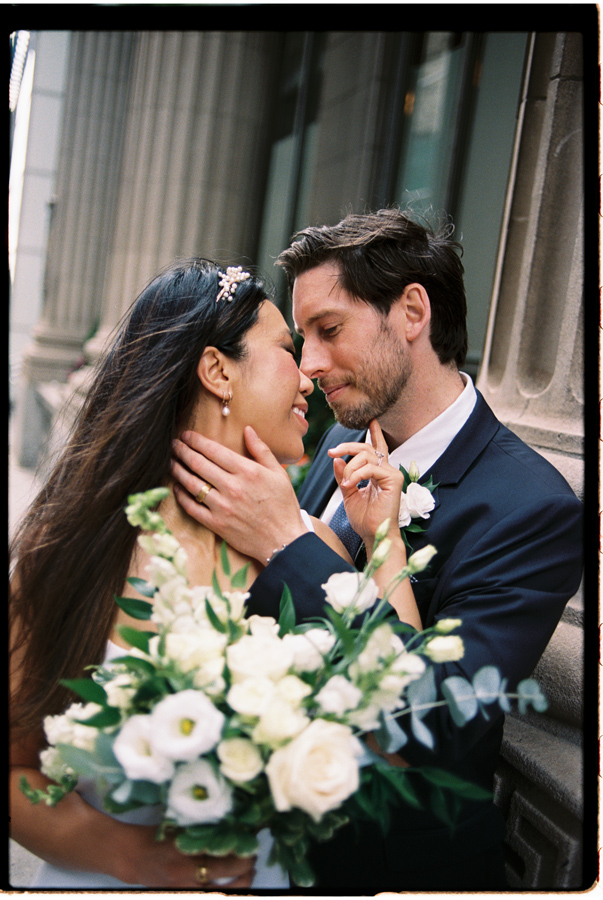 Couple who had Toronto City Hall wedding embracing in a romantic pose in colour film