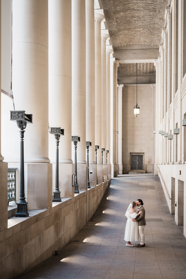 Couple kisses at Union Station just before they get married at Toronto City Hall